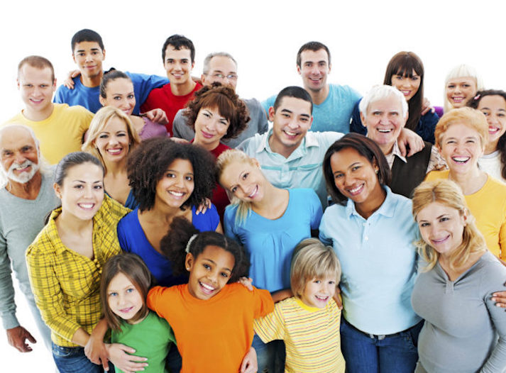 Portrait of a large group of a Mixed Age people smiling and embracing together.